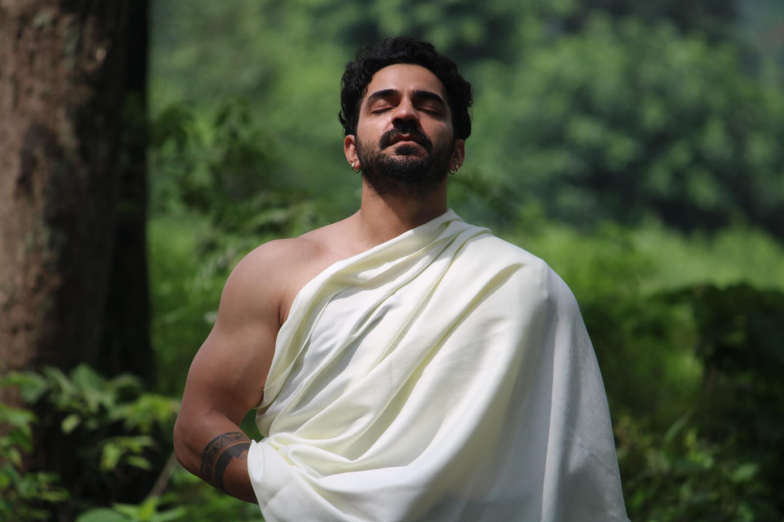Aditya Chamoli standing calmly outdoors in a forest setting