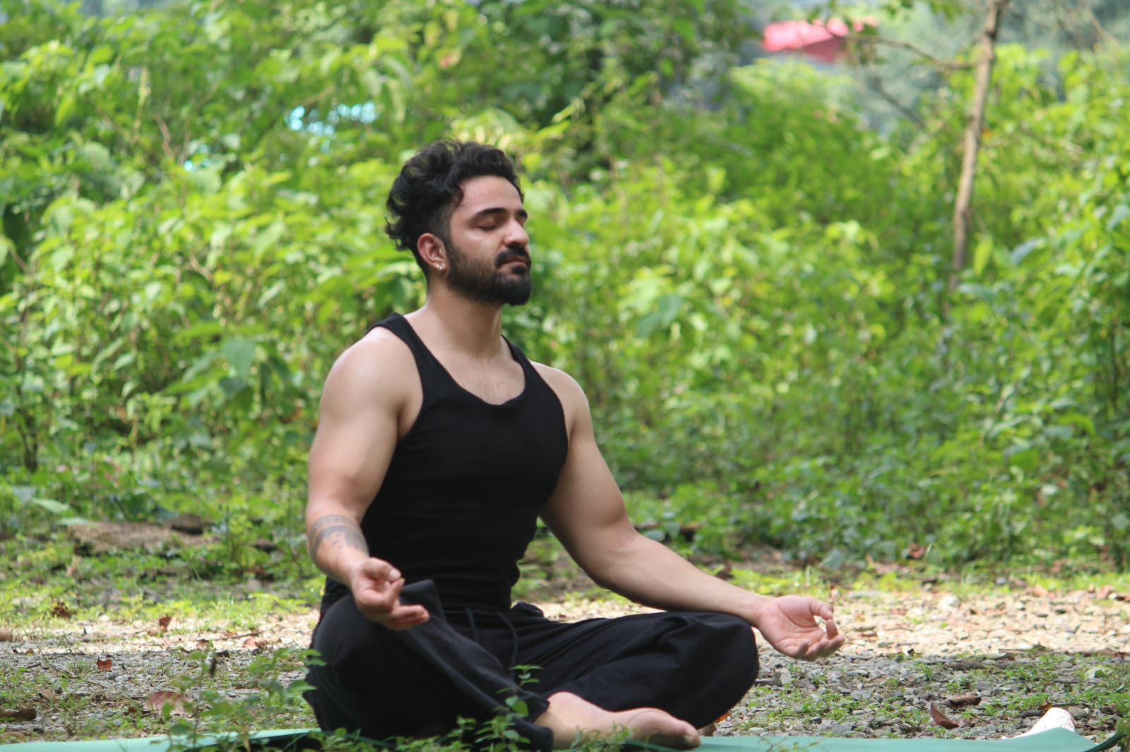 Aditya Chamoli in a seated meditative strength pose outdoors